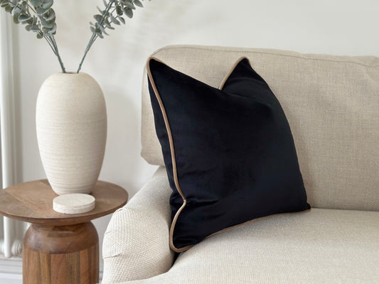 Modern black cushion with beige trim