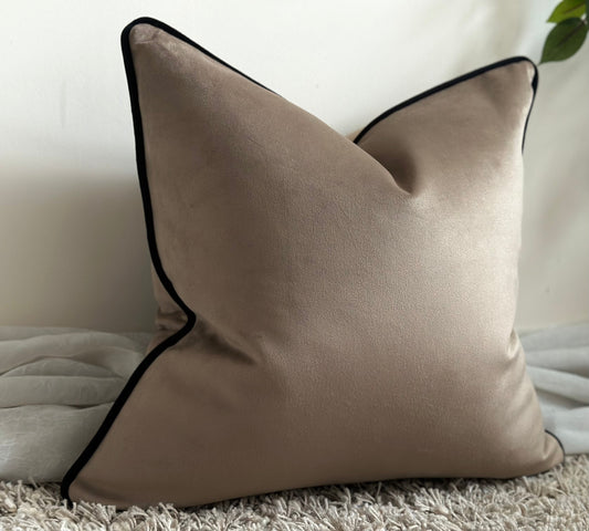 beige velvet cushion with black edge