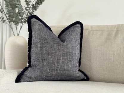 the cosy cushion shop is a high-end affordable designer cushion brand, all cushions are handmade to customers bespoke requirements in premium quality upholstery materials. in this photo is an dark blue navy cushion made in all sizes.