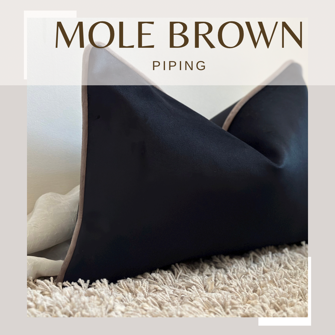 black pillow with beige brown piping trim