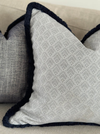 Grey pattern luxury cushions with trim.