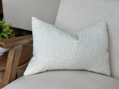 Ivory cream lumbar pillow on a minimalistic accent chair.