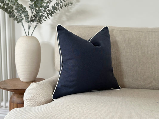 Navy plain cushion with white piping trim