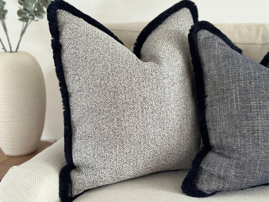 Luxury costal cool grey cushion with fringe trim.