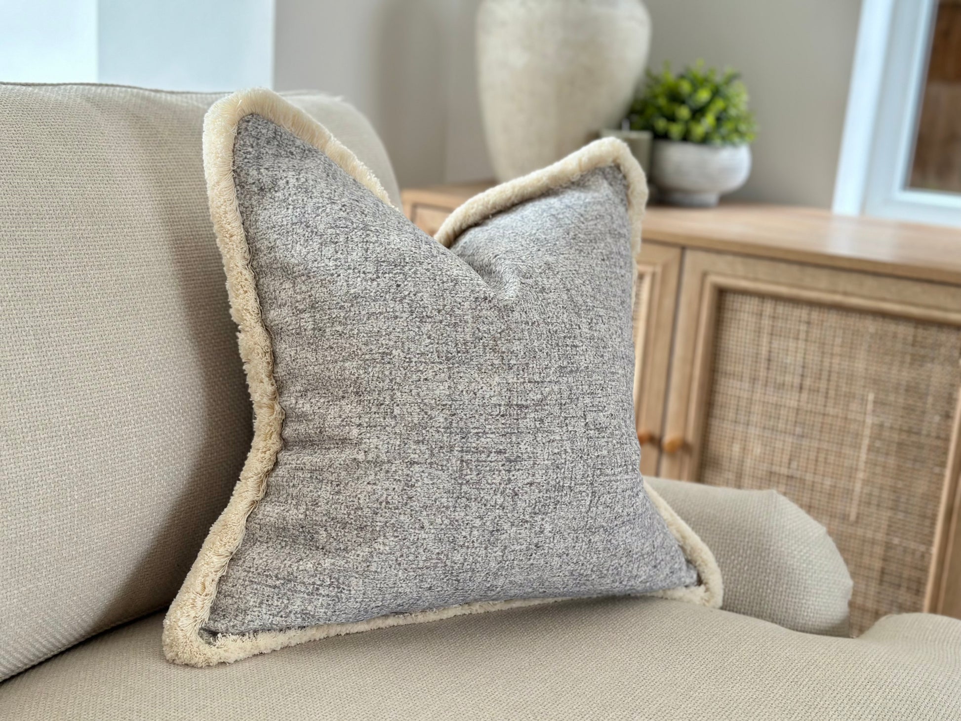 Light and airy decor, grey blue fringe cushion