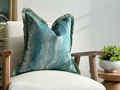 Blue and green pattern velvet cushion with fringe trim