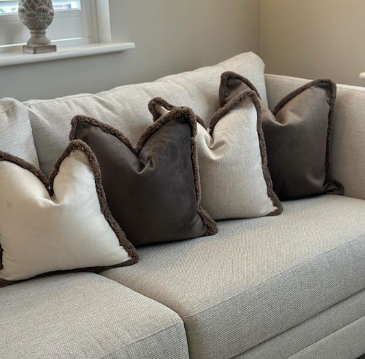 Luxury cream and brown cushions with fringe trim. Neutral home decor.