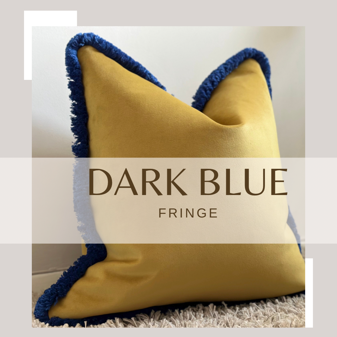 mustard pillow with blue fringe trim