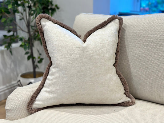 Textured ivory white pillow with brown fringe trim