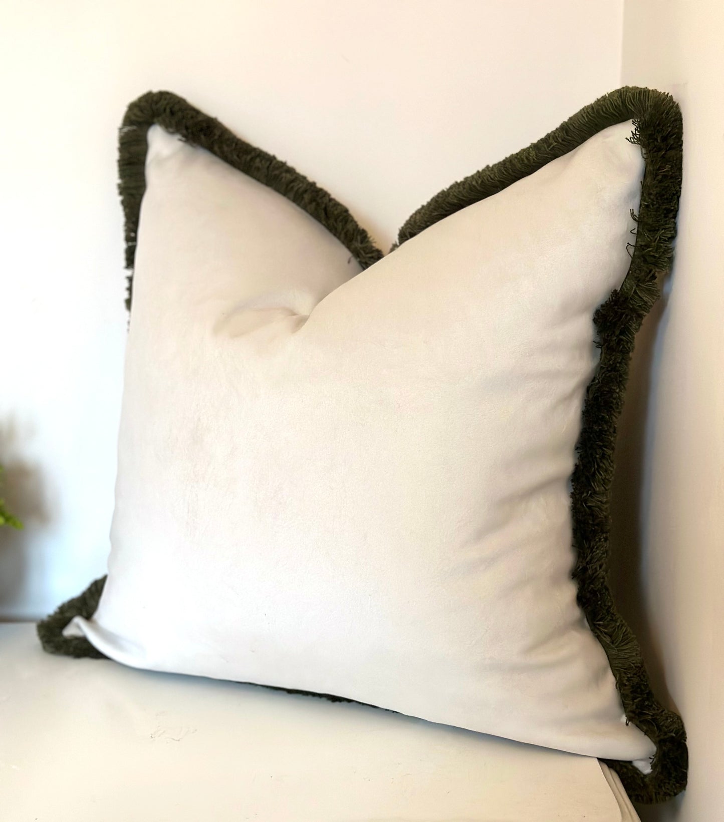 Ivory velvet cushion with moss green fringe