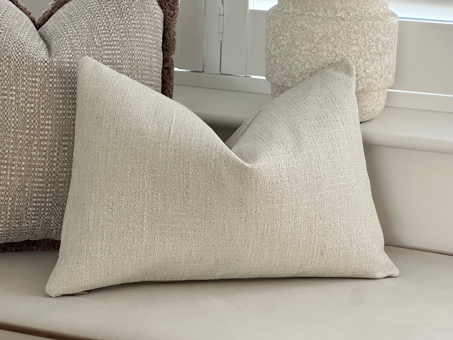 Textured ivory rectangle cushion.