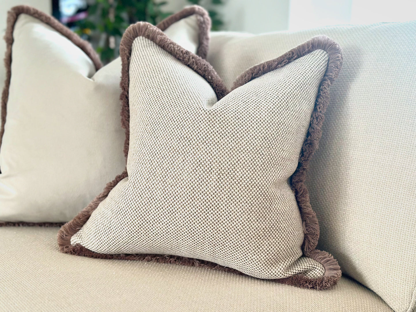 Neutral cream beige textured fringed cushion