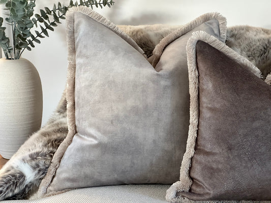 Luxury neutral light grey velvet cushion with frayed-edge trim, styled for Cosy home decor.