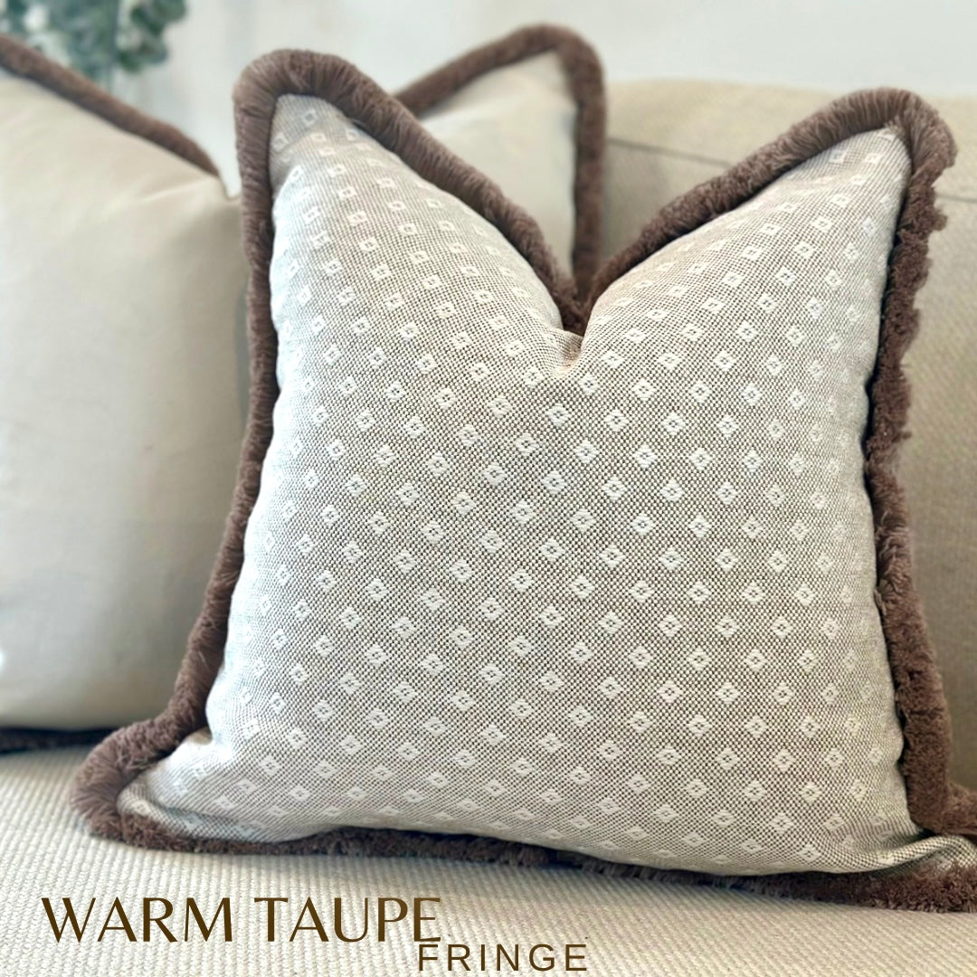 A small cream beige patterned cushion with fringe. Bespoke made in small,medium, large.