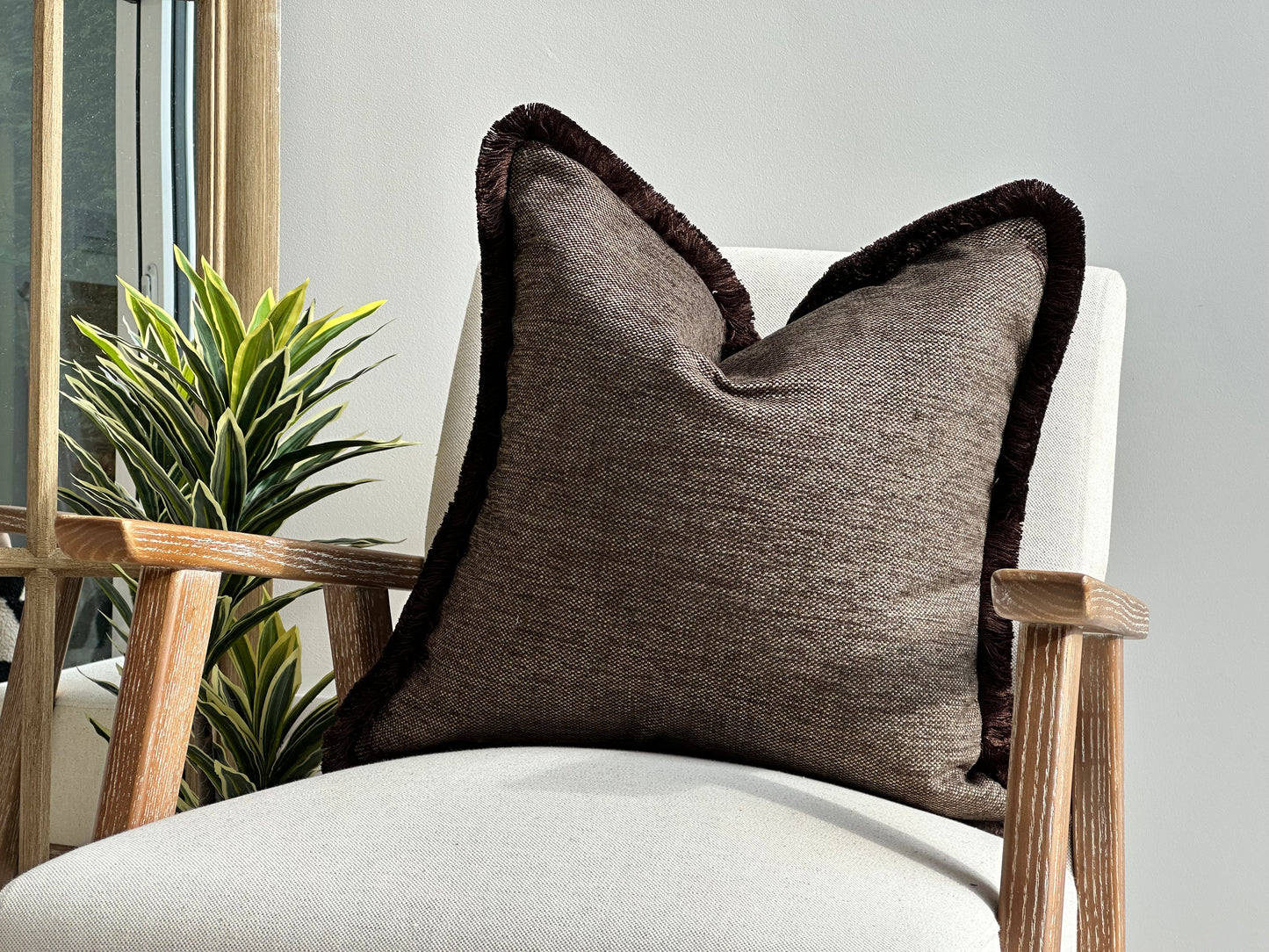 Brown textured cushion with fringe. Perfect for modern organic decor