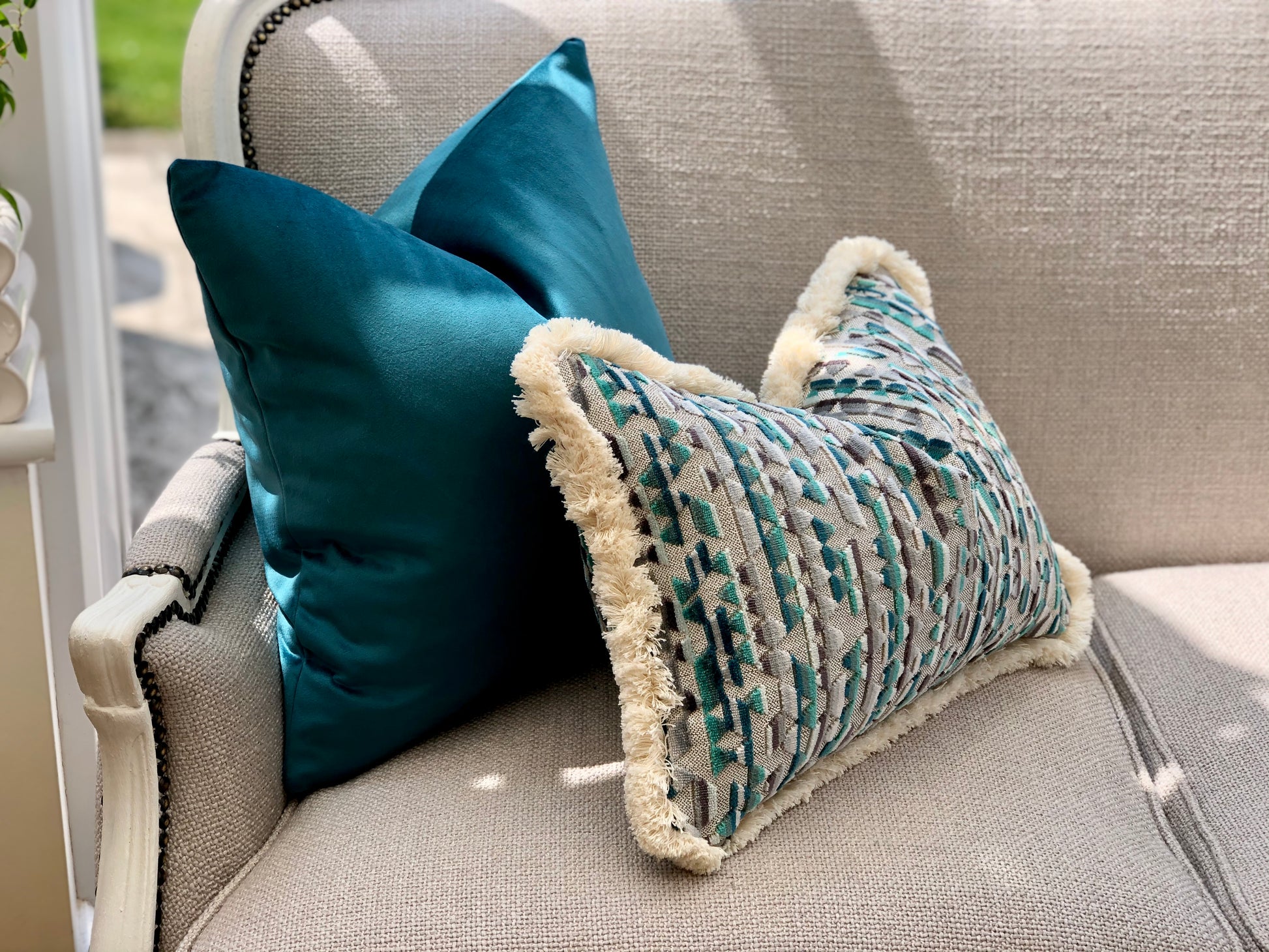 Teal fringed pillows