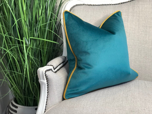 teal cushion with mustard piping