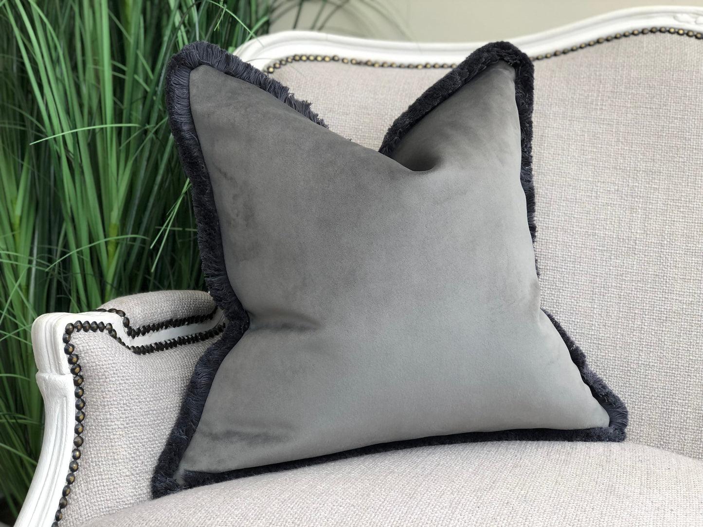 large grey fringe cushion