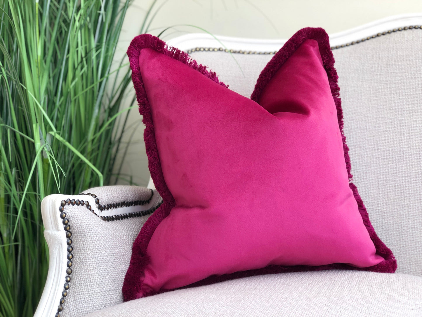 bright pink cushion with fringed edge