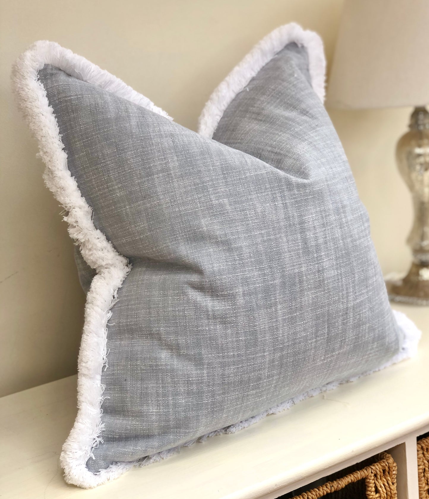 blue cushion with white trim