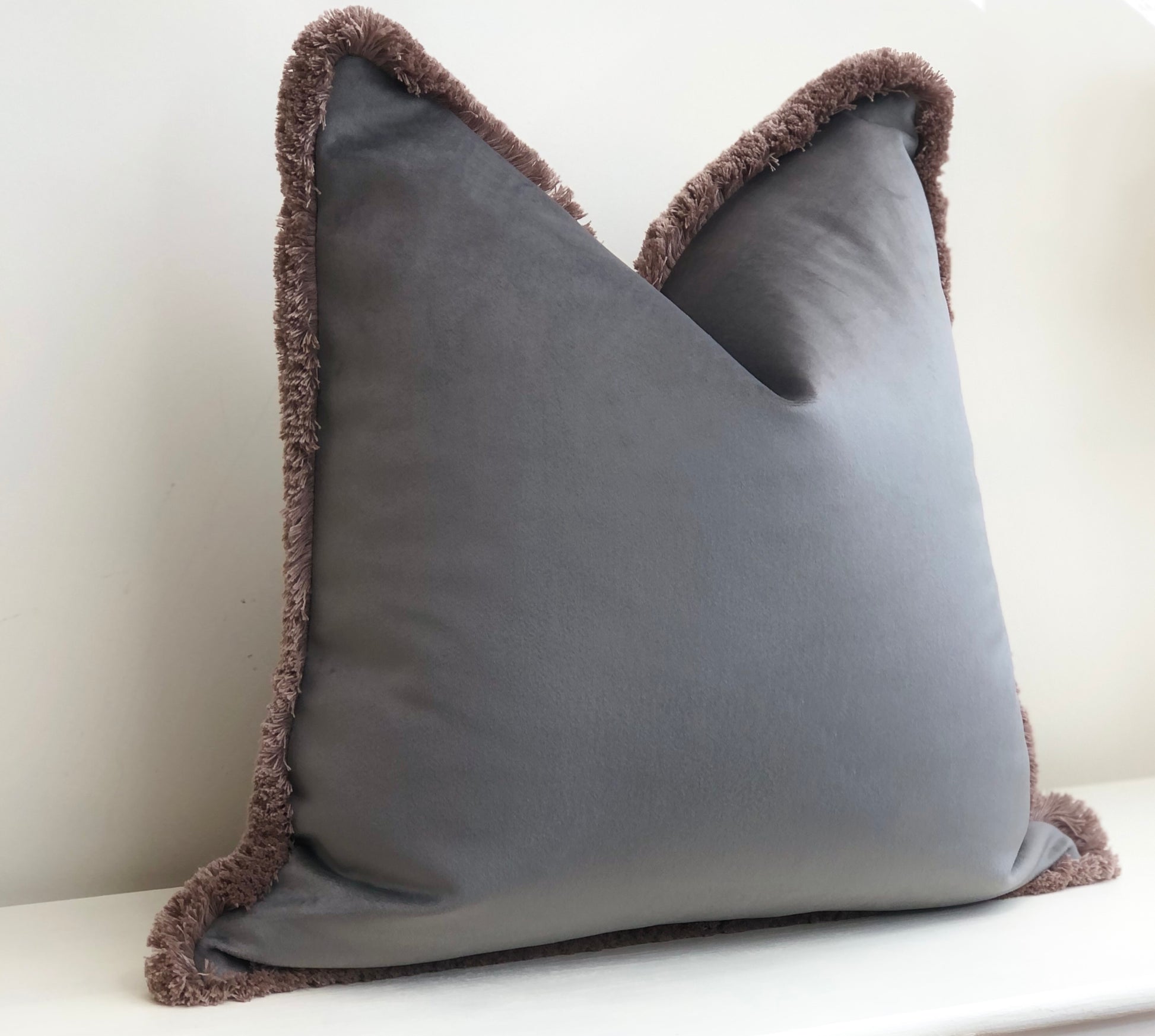 Grey fringe outlet cushion