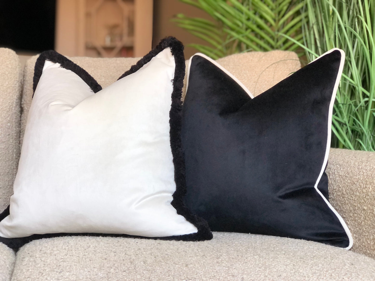 white cushion with black fringe