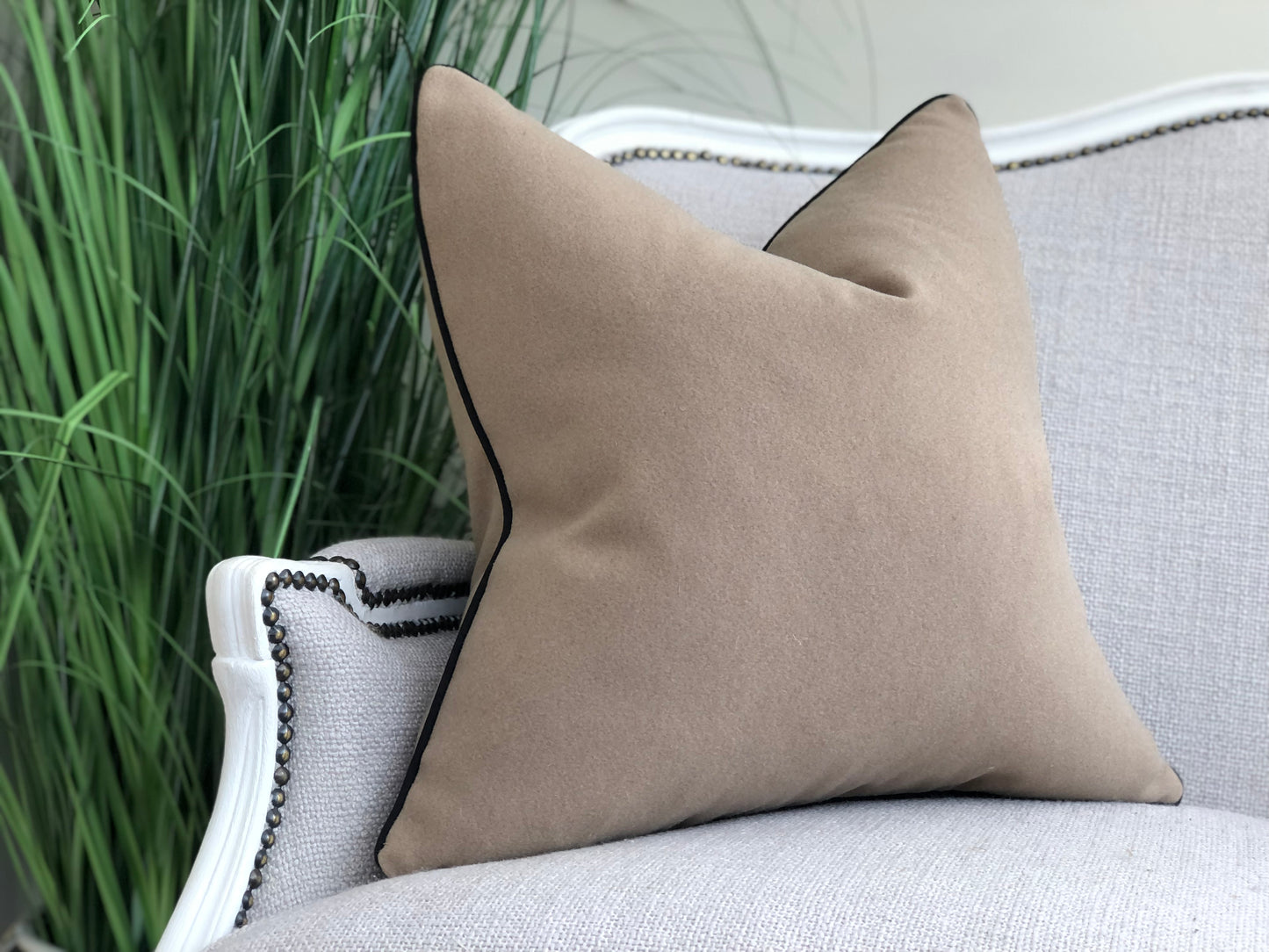 beige cushion with black trim