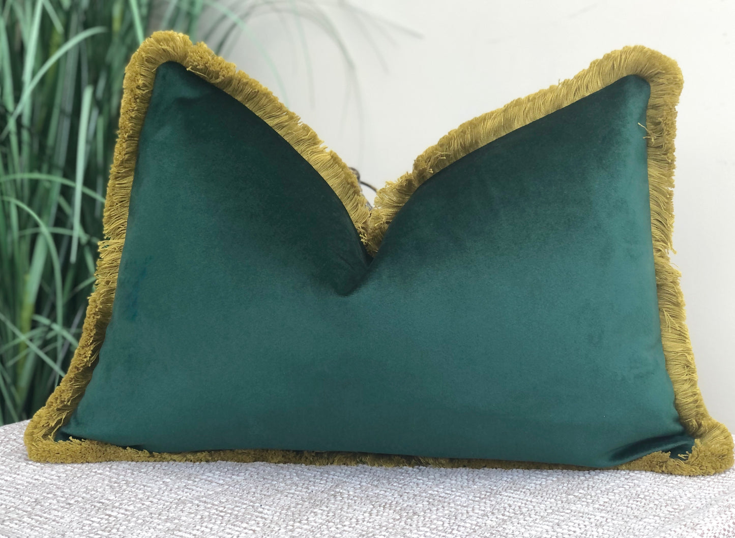 green cushion with fringe