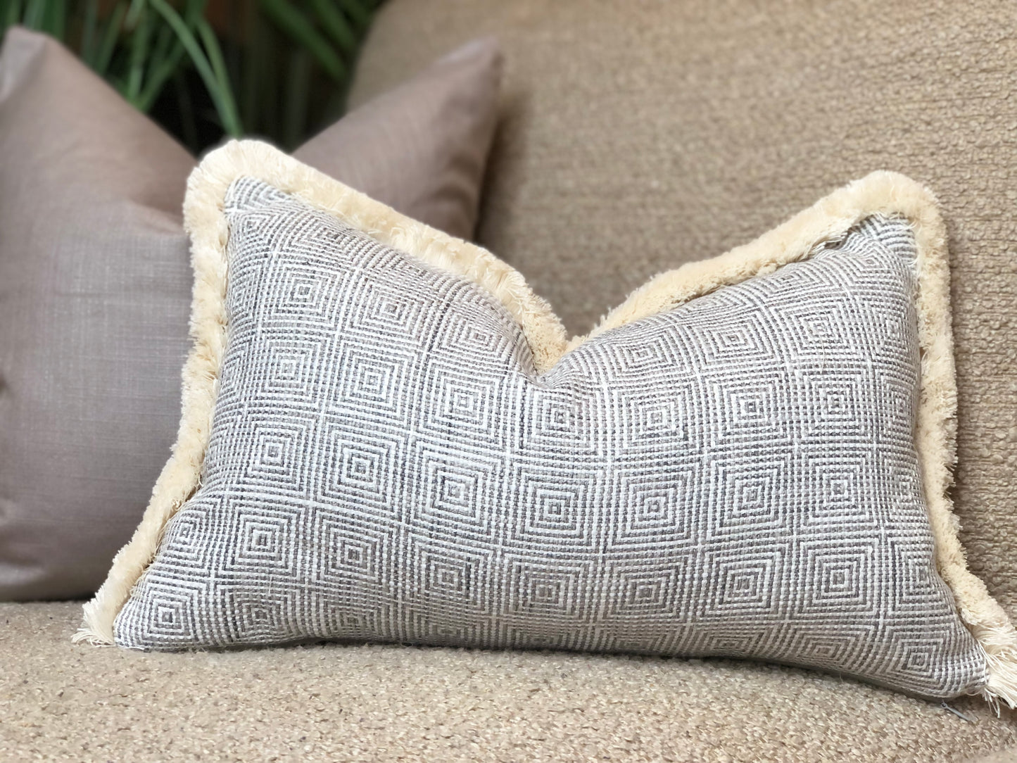 patterned grey cushion with trim