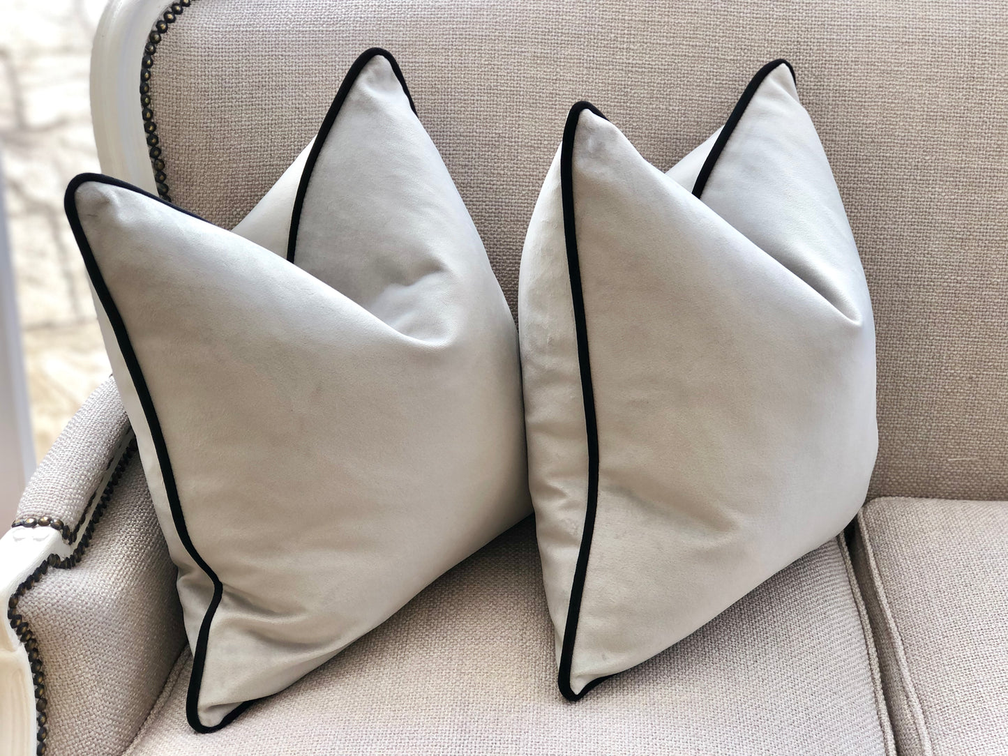 silver cushion with black piping