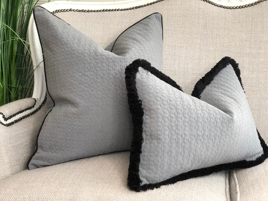 textured grey cushion with fringe