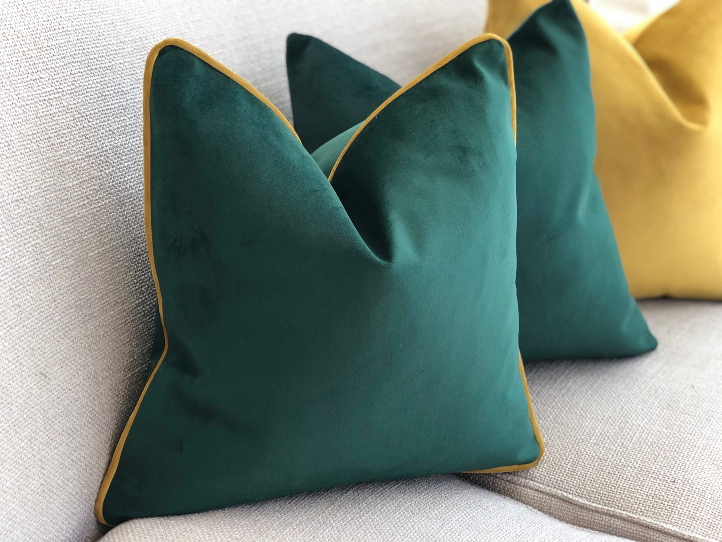 emerald green velvet cushion with mustard piping