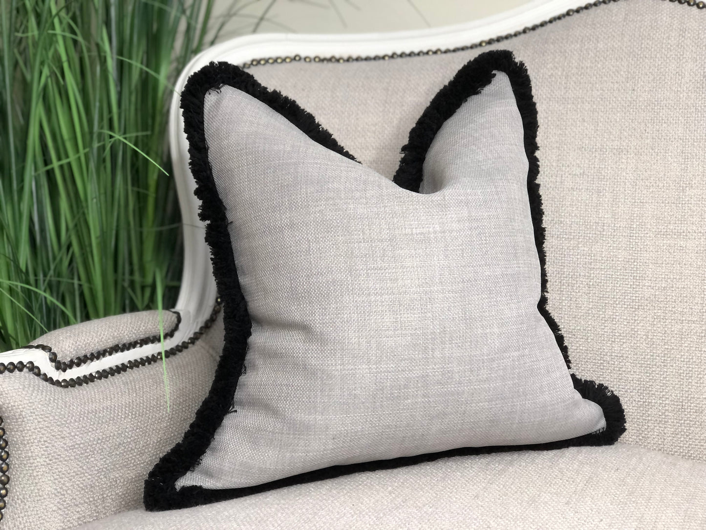 light grey cushion with black edge